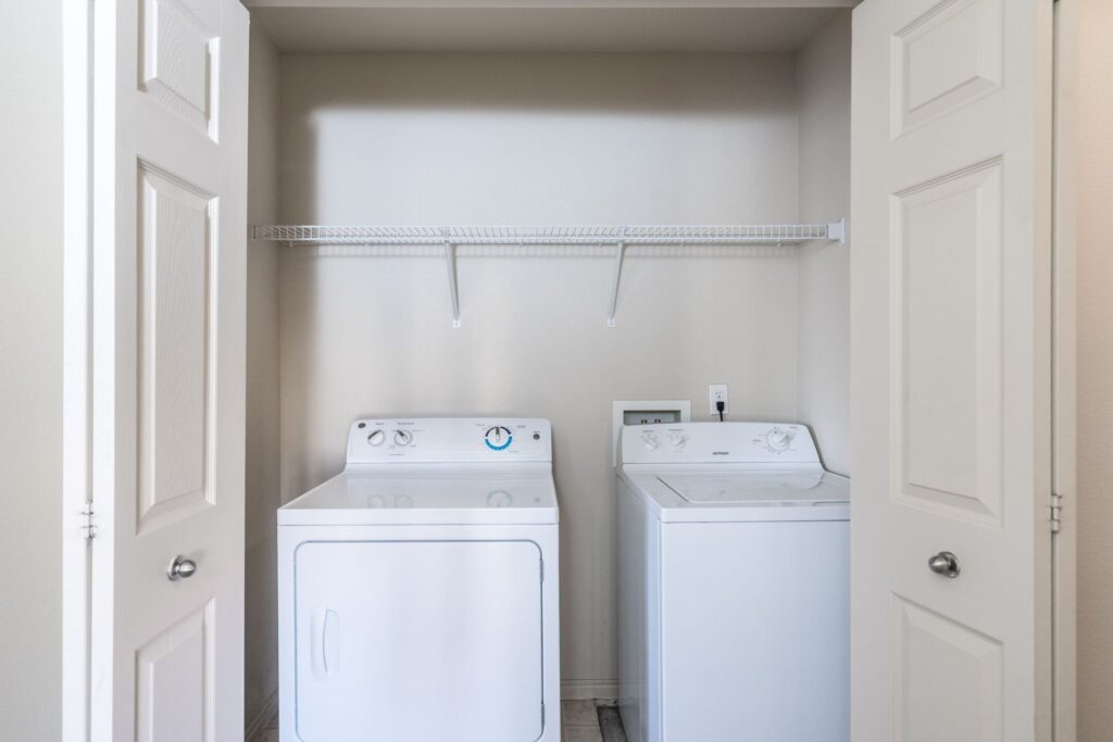 Closet with washer and dryer and built in shelves