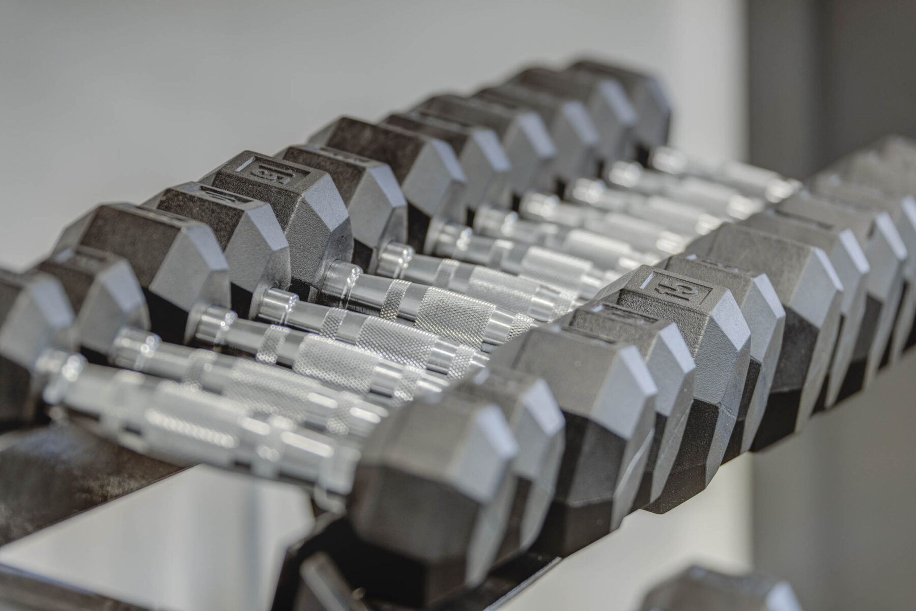 a row of dumbbells on a stand