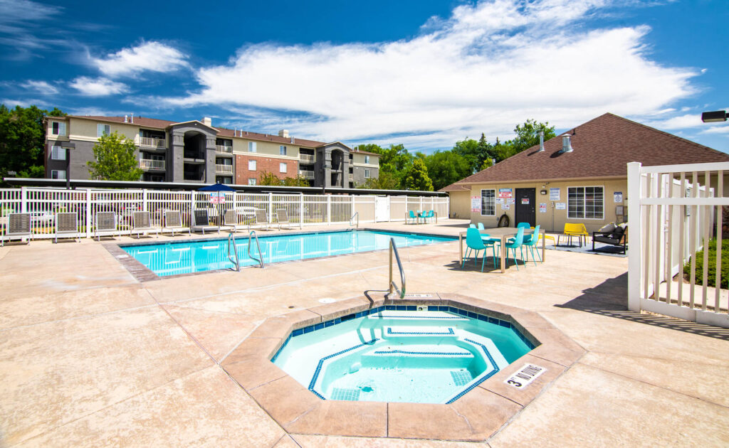 Pool and spa with surrounding deck chairs