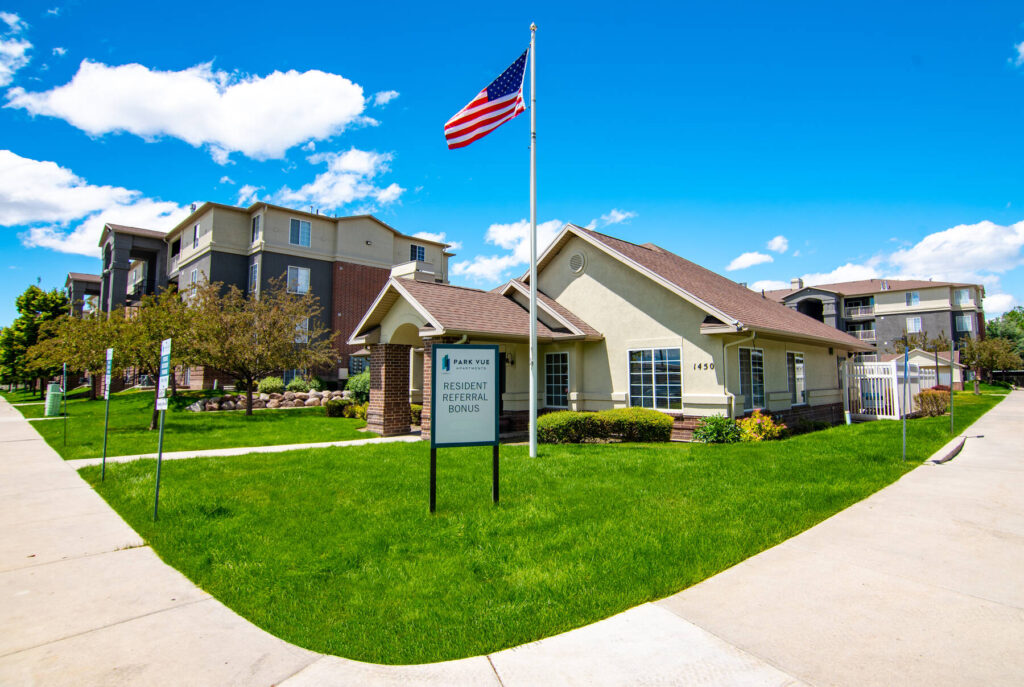 Clubhouse exterior with signs that reads resident referral bonus