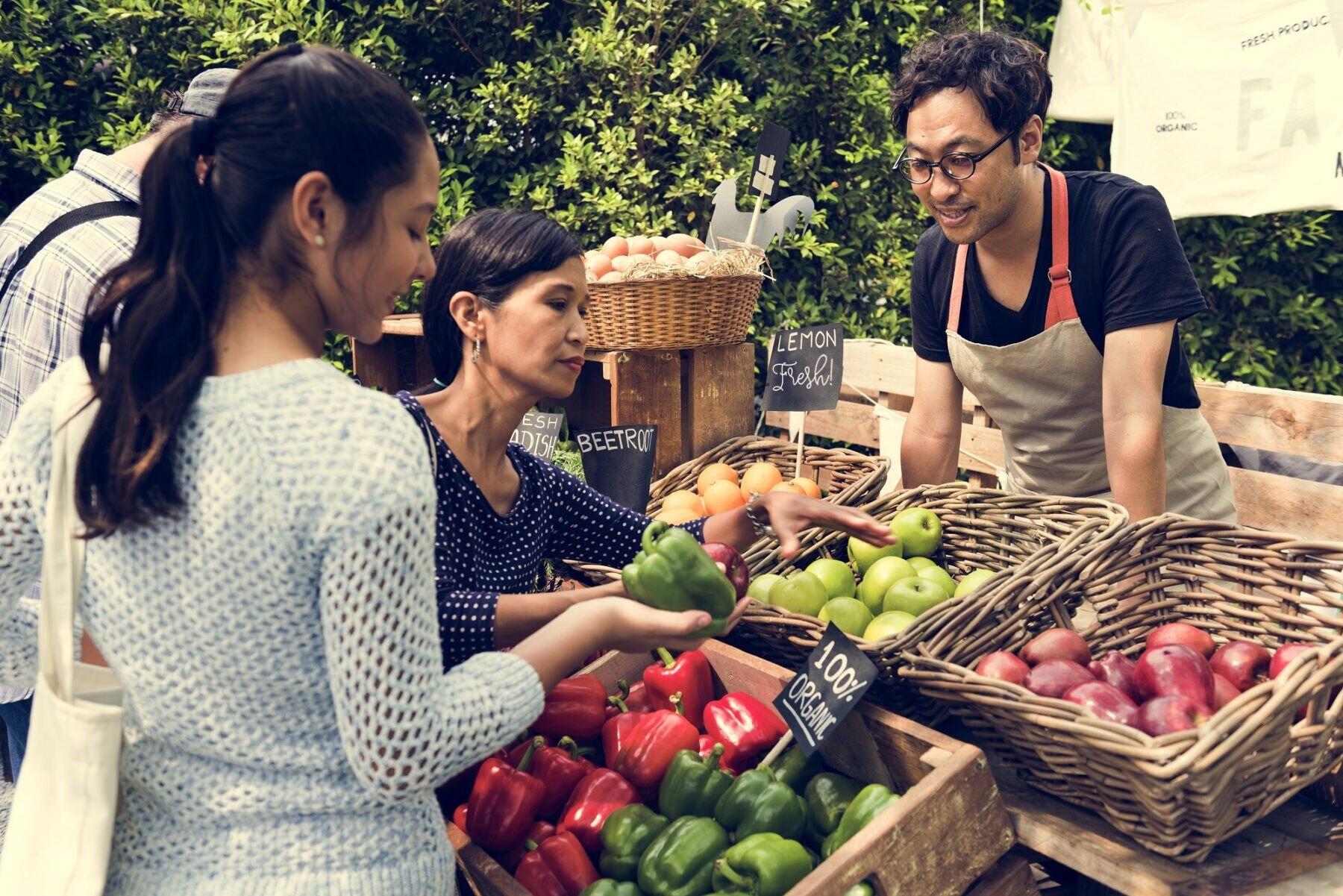 people getting fruit at farmers market