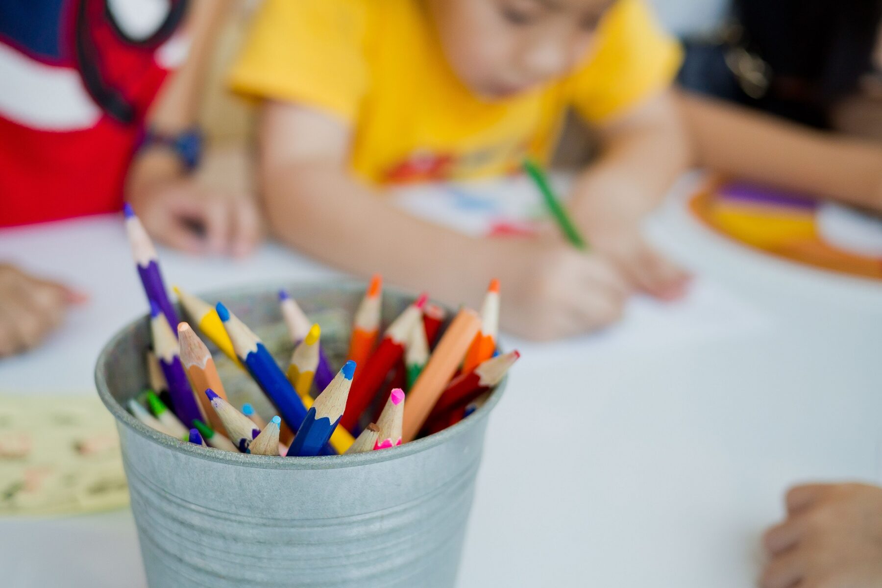 a child with a color pencil drawing